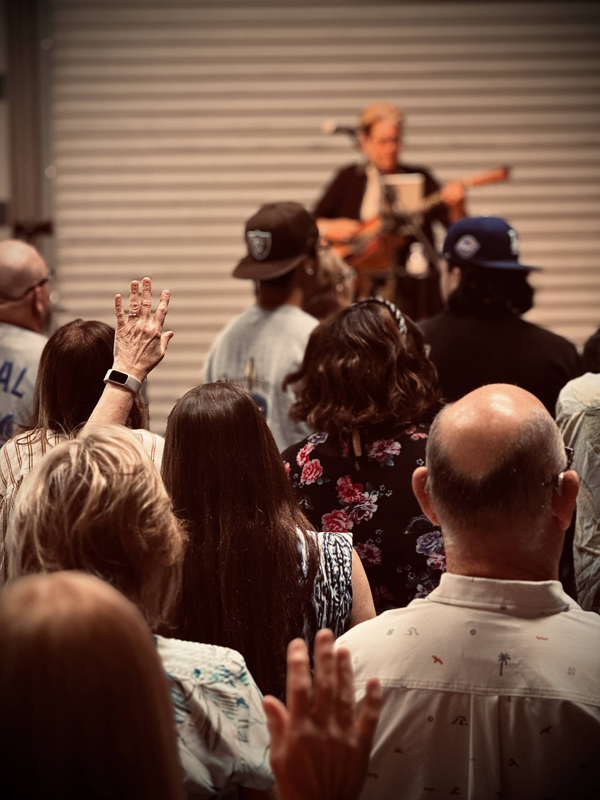 People participating in worship during a Sunday service at The Bridge Church.