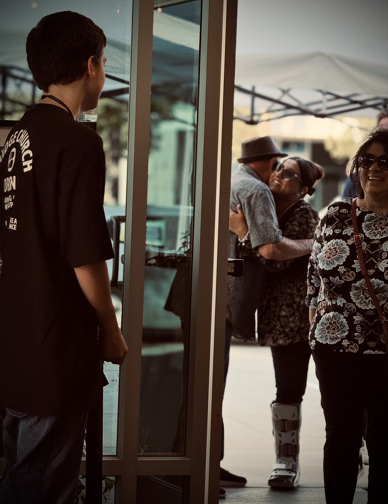 People arriving and gathering in the welcome area at The Bridge Church.